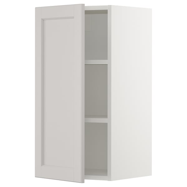 An open white ikea SEKTION wall cabinet with a single adjustable shelf. It a clean, classic design with a smooth, flat panel door.