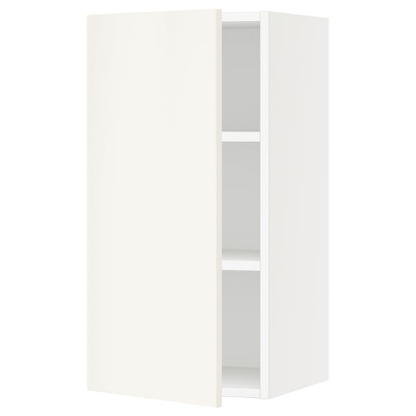 A white SEKTION kitchen wall cabinet with a single adjustable shelf and a door that can open left or right.
