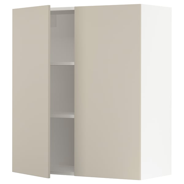 A beige SEKTION kitchen cabinet with one door open, revealing adjustable shelves and a soft-close hinge.