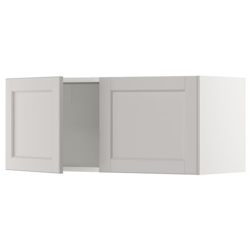 White kitchen cabinet with one open door, bevelled edges.