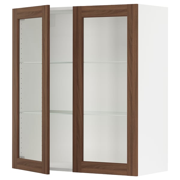An open white wall cabinet with wooden frames and glass shelves.