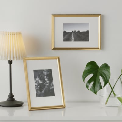 Minimalist decor: butterfly & road art, lamp, plant.