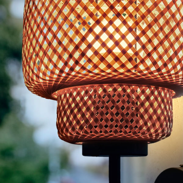 Intricate bamboo pendant lamp, handwoven, warmed glowing light, natural design.