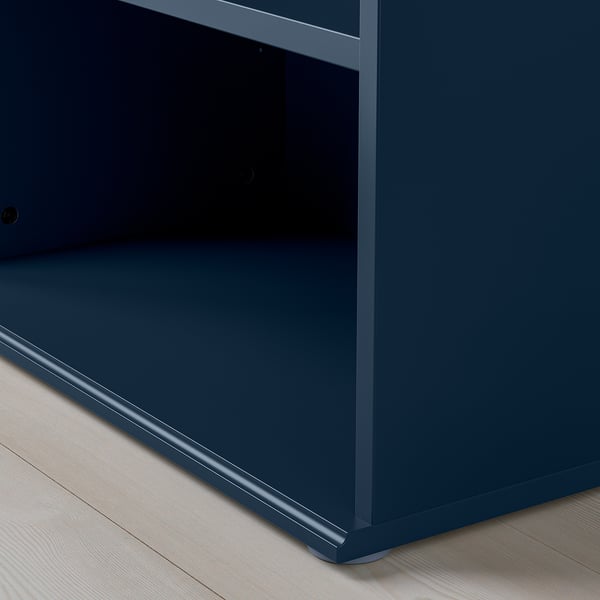 Modern blue cabinet with sleek edges and adjustable feet, sitting on wooden floor.