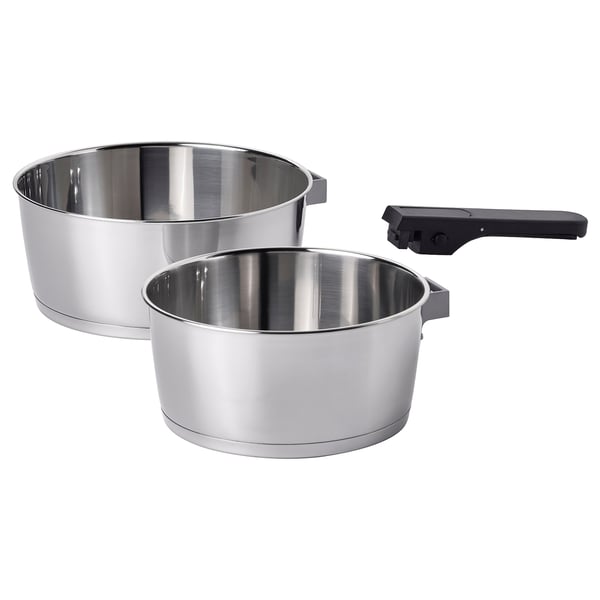 Two stainless steel SLÄTROCKA saucepans with detachable black handles. Designed for efficient cooking and easy storage.