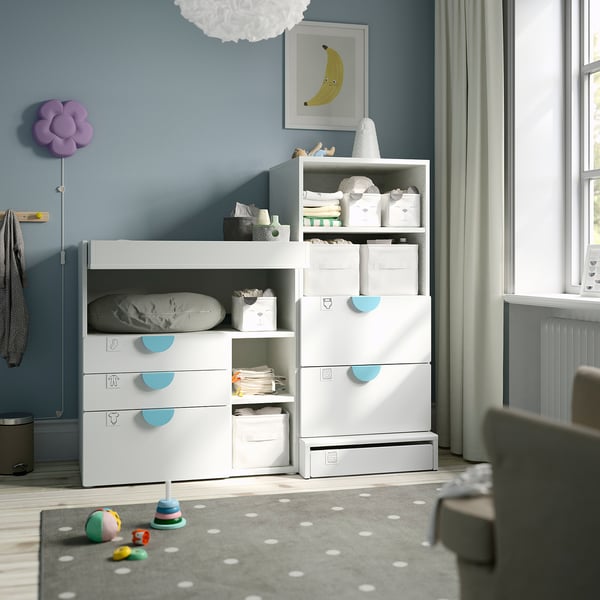 Babys nursery with SMÅSTAD dresser, toys, and large window.