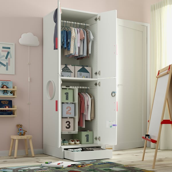 Kids wardrobe with clothes, toys, and storage bins. It has a smooth-closing door and adjustable shelves.