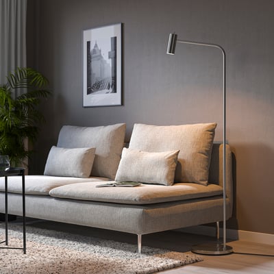 Modern living room with a light grey SÖDERHAMN sofa, beige pillows, a black floor lamp, and a black & white picture on a dark wall.