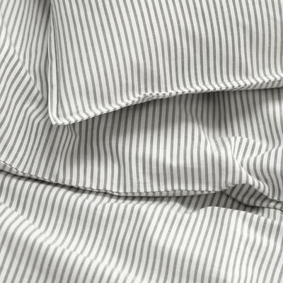 A neatly folded grey and white striped bed sheet. Crisp, clean lines and even stitching suggest high quality cotton.
