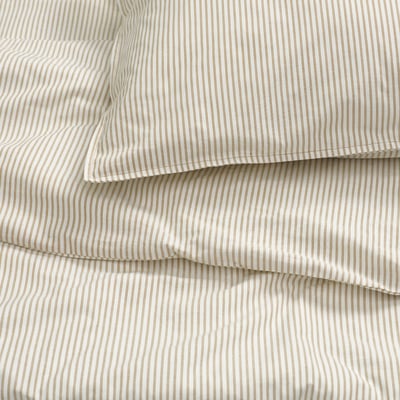 Close-up of cream striped bedding, showcasing smooth cotton texture. Folded neatly, highlighting stitching detail.