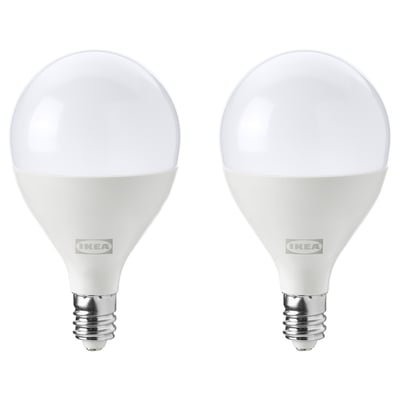 Two white ikea SOLHETTA led light bulbs with warm-white light, round shape, made of durable plastic.