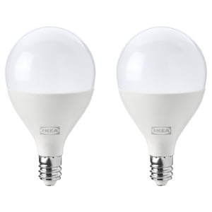 Two ikea led light bulbs, white, spherical shape, stand upright; provide warm-white light.
