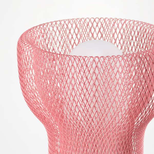 Close-up of pink mesh lamp, showcasing intricate design and modern texture. Aesthetic decorative piece.
