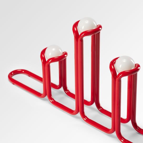 Three red, braided candlesticks with white, spherical light bulbs at their tops, creating a modern and playful design.