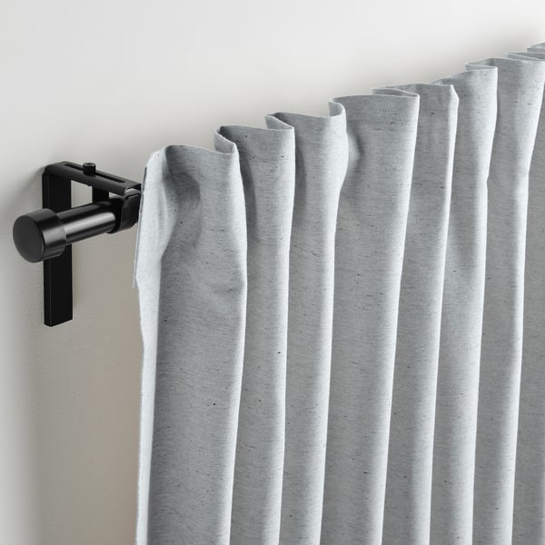 Grey curtains on black rod, partially open for light control.