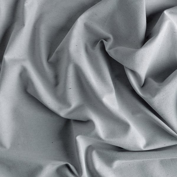 Curtain of textured, grey fabric, showcasing recycled material with subtle folds, giving a smooth, woven feel.