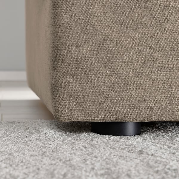 A sleek, modern sofa with soft, textured fabric and sturdy black legs, offering comfort and style.