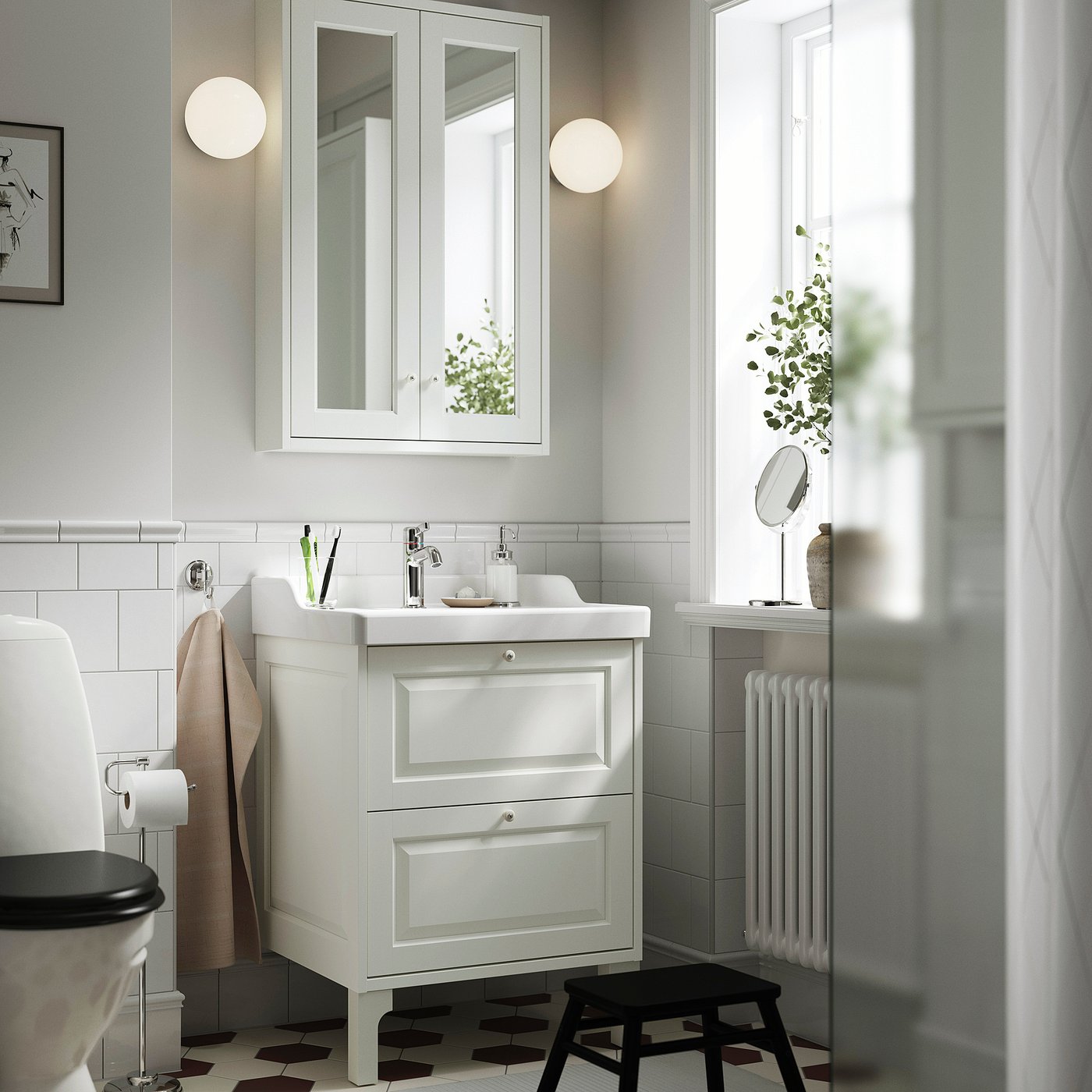 White TÄNNFORSEN mirror cabinet with bevelled panels, wall-mounted above vanity sink, large and reflective.