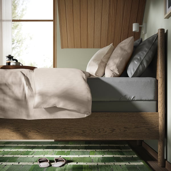 Bed with adjustable sides and high mattress base for easy access and better sleep support.