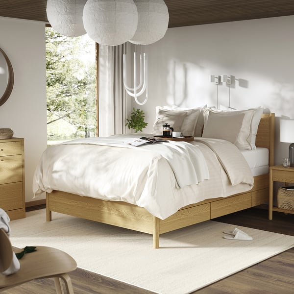 Minimalist bedroom light wood TONSTAD bed with white linens and hanging lamps. Modern and clean design with natural light.
