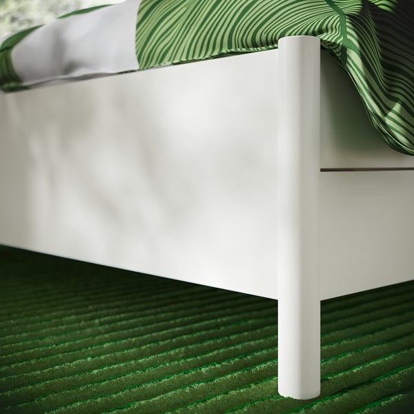 Close-up of TONSTAD bed frame leg. Sleek, white finish, sturdy design, high-quality construction.
