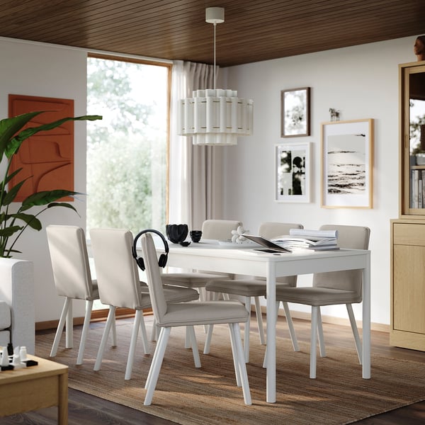 A white TONSTAD dining table with six chairs, large window, and plant.
