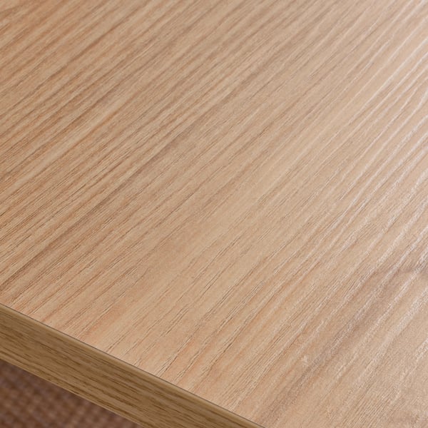 Close-up of TROTTEN desk surface. Smooth, clean finish with subtle wood grain pattern.