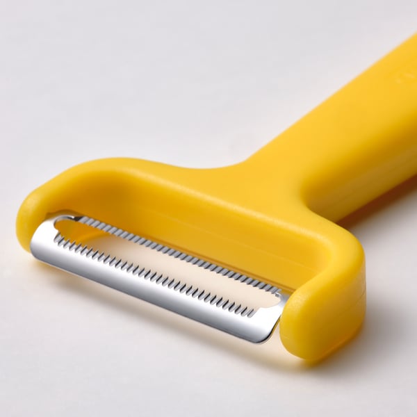 Yellow vegetable cutter, bright and practical. Stainless steel blade, secure grips, sharp and precise.