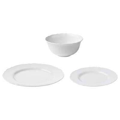 Three white porcelain items: one bowl and two plates, all with a soft ruffled edge design.