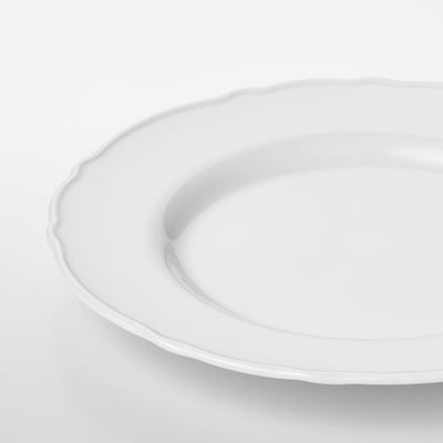 Crisp white porcelain plate with delicate, ruffled edge. Smooth, durable, and elegant.