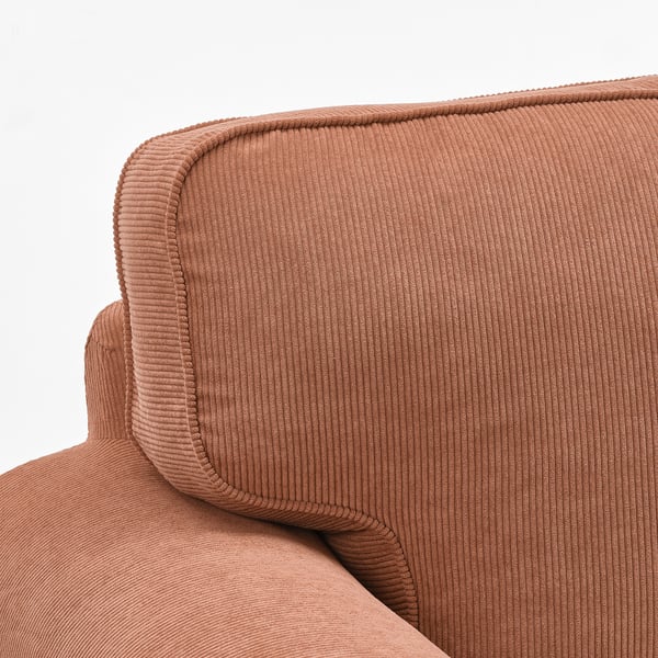 Close-up of cushy, textured brown corduroy chair back, showcasing soft, inviting texture and neat stitching.