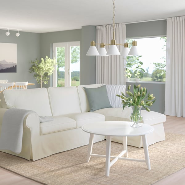 Modern living room with UPPLAND sofa, blue accents, and natural light.