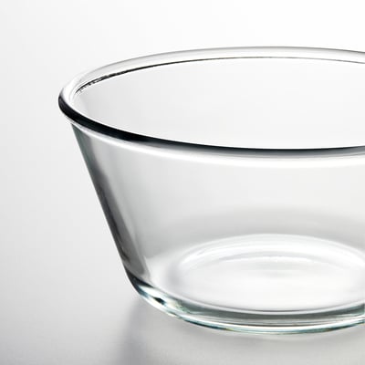 Clear glass bowl, modern design. Round, smooth edges. Transparent and empty.