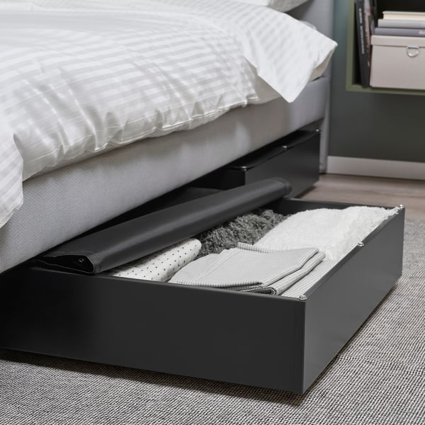 Under-bed storage box with fabric lid, featuring castors for easy access.