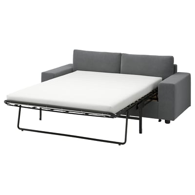 Grey VIMLE sectional sofa-bed with thick, white mattress. Modern design, metal frame, convertible for sleeping.