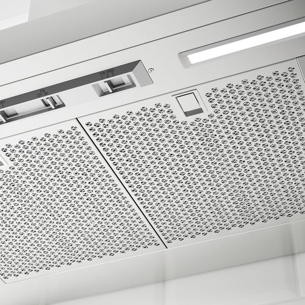 Modern stainless steel range hood with perforated panels and control panel.