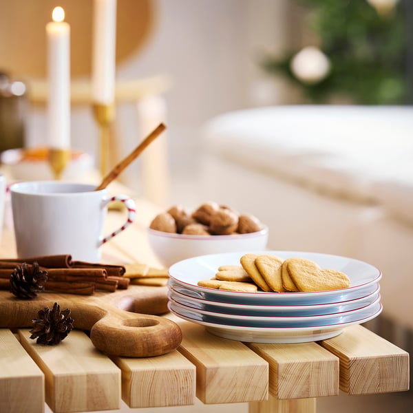 Wooden table with VINTERFINT plates and cookies.