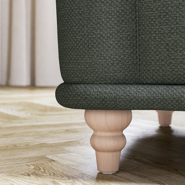 A dark green fabric sofa with wooden legs. Classic design, soft rounded shapes, and inviting seat.