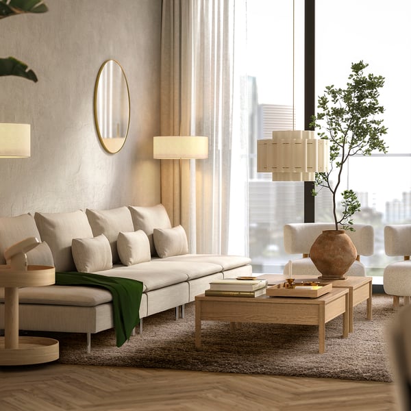 Luxurious living room with VOLLERSLEV shaggy rug, cream sofa, coffee table, modern lamp, mirror, city view window, plant, and vase.